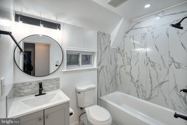 full bathroom featuring toilet, tiled shower / bath combo, and vanity