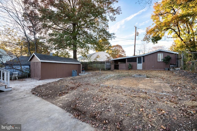 back of house with an outdoor structure