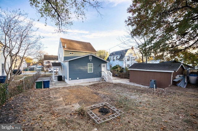 back of property with a storage shed