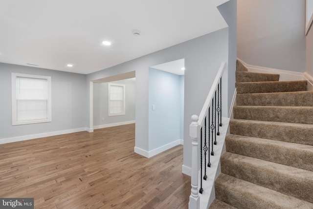 stairway with hardwood / wood-style floors