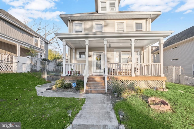 view of front facade featuring a front yard and a porch