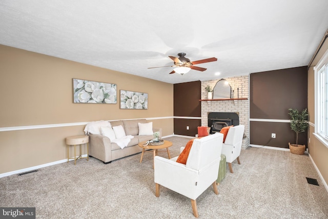 carpeted living area with a ceiling fan, baseboards, and visible vents