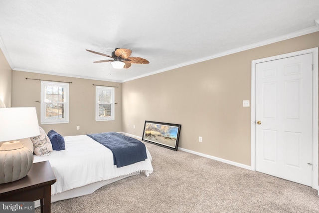 carpeted bedroom with a ceiling fan, baseboards, and ornamental molding