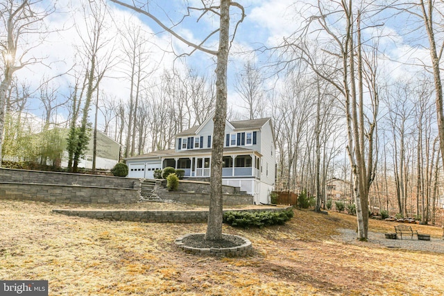 view of front of home with a garage and fence