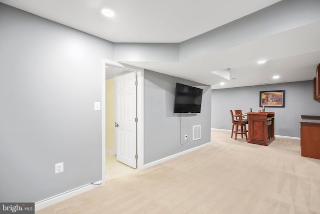 interior space with recessed lighting, visible vents, light colored carpet, and a bar