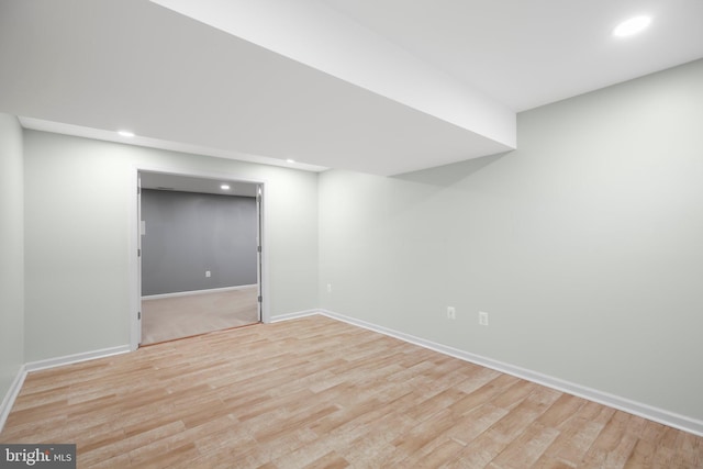 finished below grade area with recessed lighting, baseboards, and light wood-style flooring