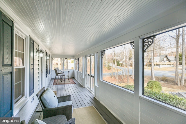 sunroom featuring wood ceiling