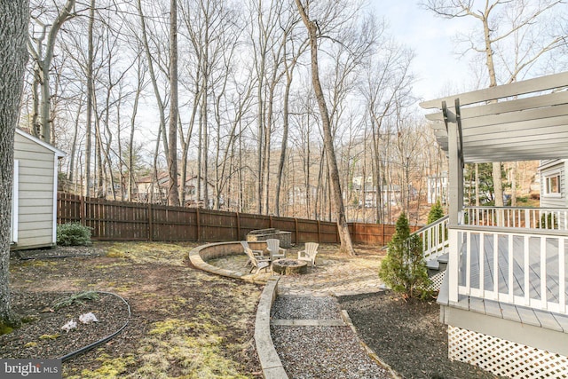 view of yard featuring a fire pit and fence