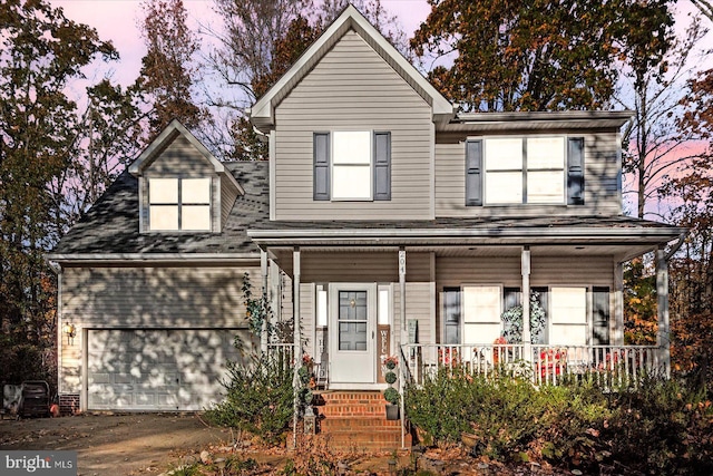 view of front property with a garage and a porch