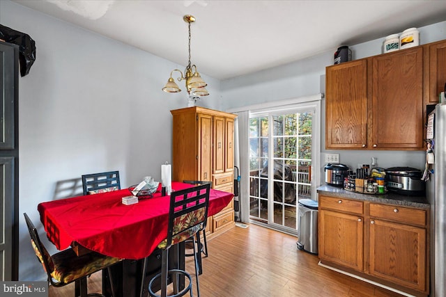 dining room with hardwood / wood-style flooring and a notable chandelier