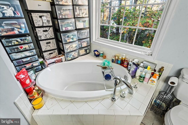 bathroom with tiled bath and toilet