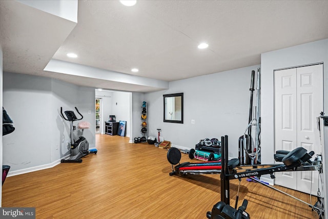 workout area with a textured ceiling and hardwood / wood-style flooring