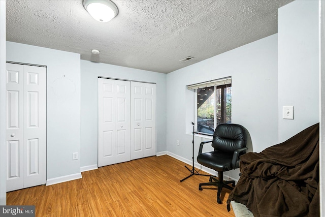 office area featuring a textured ceiling and hardwood / wood-style flooring