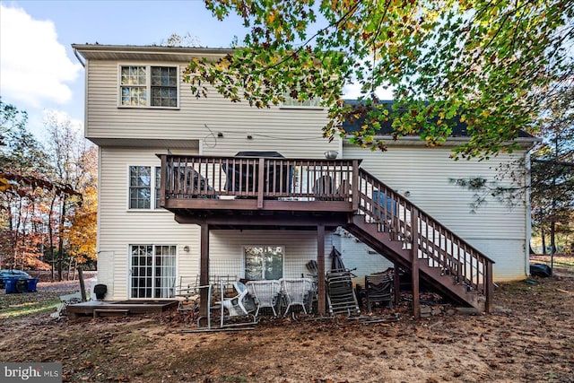 back of property featuring a wooden deck