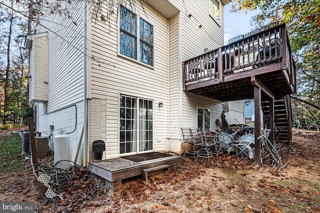 rear view of house featuring cooling unit and a deck