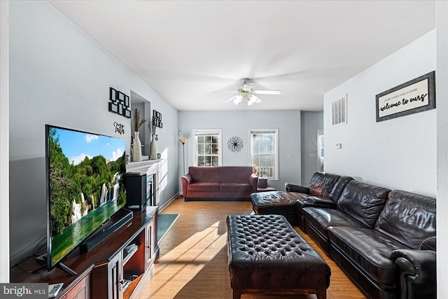 living room with ceiling fan and light hardwood / wood-style floors