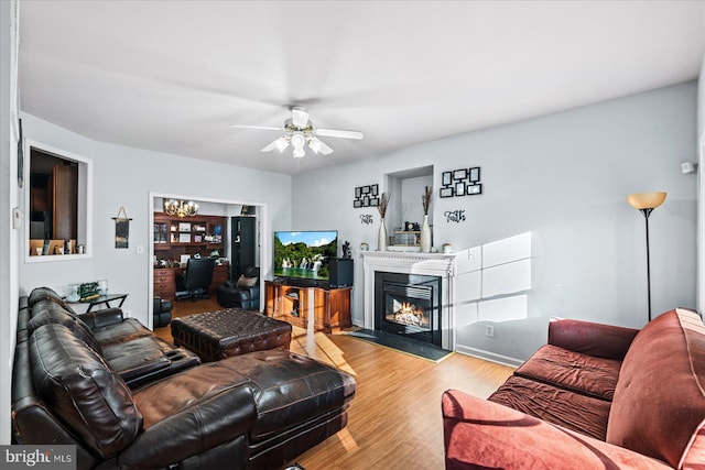 living room with ceiling fan and light hardwood / wood-style flooring