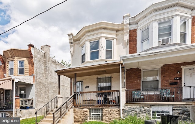 townhome / multi-family property with a porch