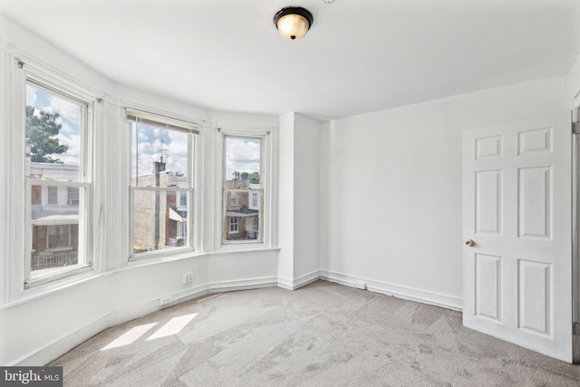 empty room featuring light colored carpet