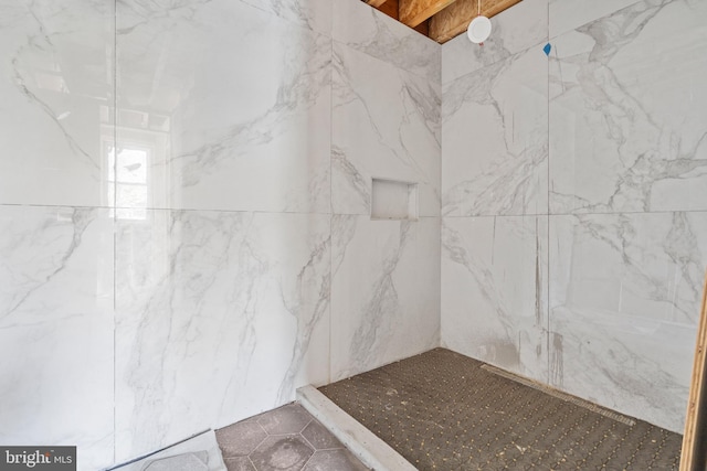 bathroom with tiled shower