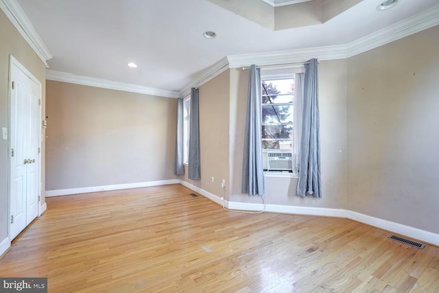 empty room with light hardwood / wood-style flooring and ornamental molding