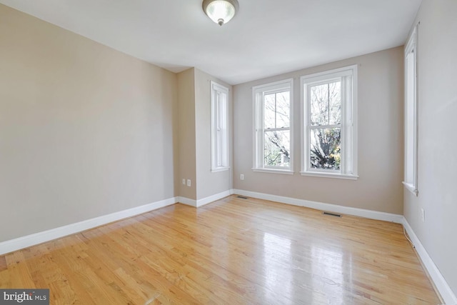 spare room featuring light wood-type flooring