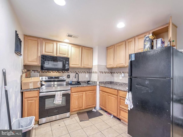 kitchen featuring light brown cabinetry, backsplash, sink, black appliances, and light tile patterned floors