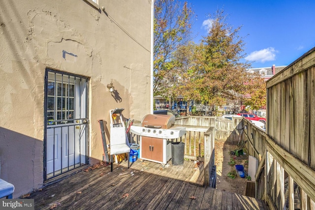 wooden deck featuring area for grilling