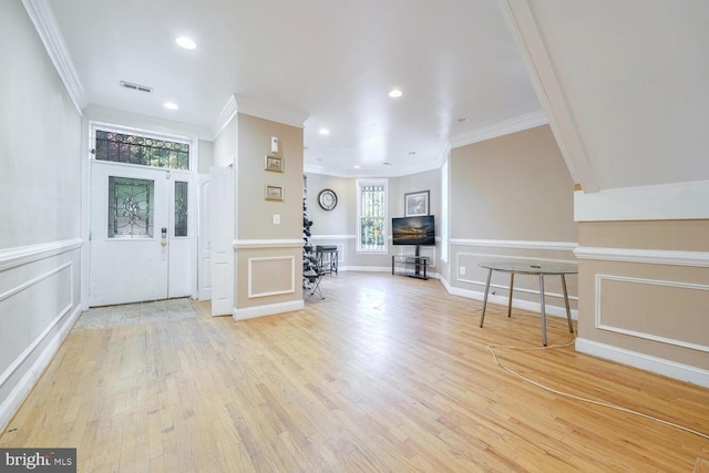 entrance foyer featuring light hardwood / wood-style floors and ornamental molding