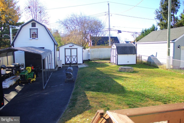 view of yard with a shed and a carport