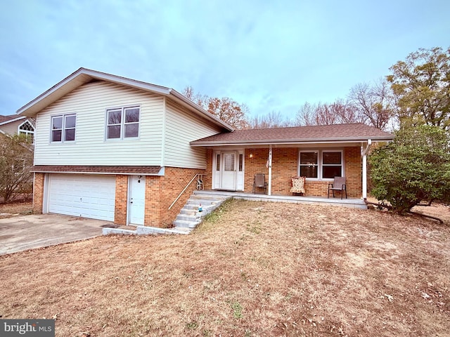 split level home with a garage and a porch