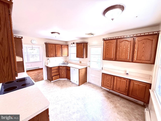 kitchen with sink, stovetop, white dishwasher, and a baseboard radiator