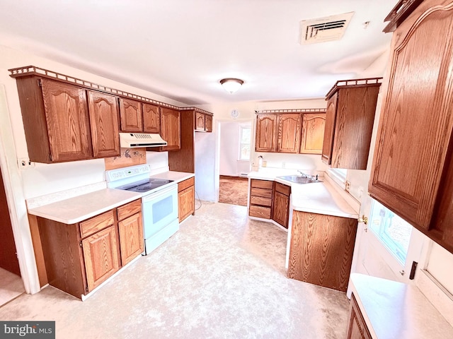 kitchen with white electric range oven and sink