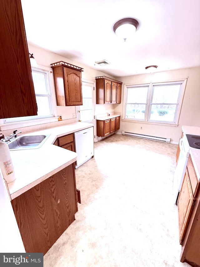 kitchen with white appliances, sink, a healthy amount of sunlight, and a baseboard radiator