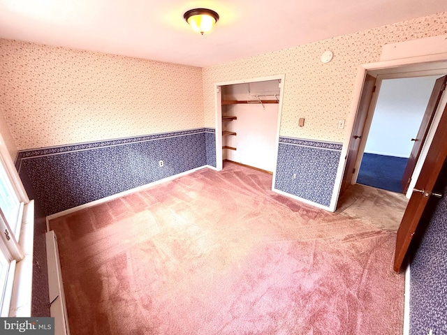 unfurnished bedroom featuring a closet and carpet flooring