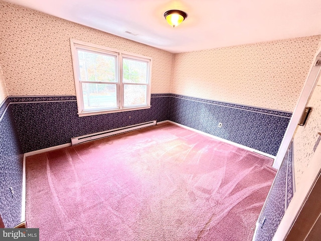 unfurnished room featuring baseboard heating and carpet floors