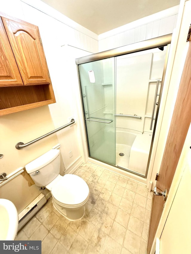 bathroom featuring a baseboard heating unit, an enclosed shower, and toilet