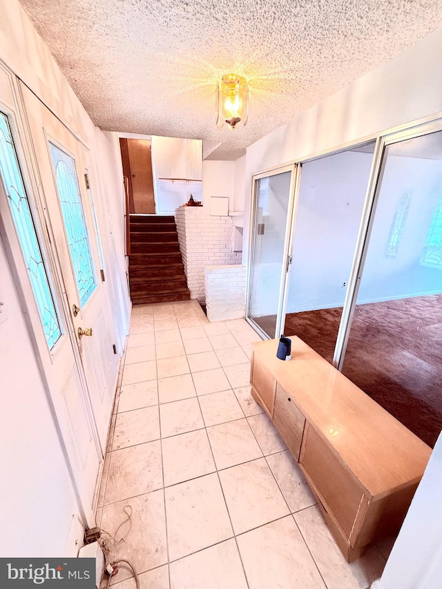 interior space featuring a textured ceiling and tile patterned floors