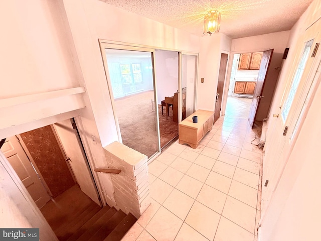 bathroom with tile patterned flooring and a textured ceiling