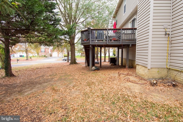 view of yard featuring central air condition unit and a wooden deck