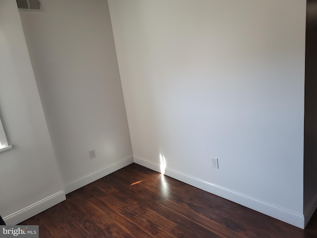 unfurnished room featuring dark hardwood / wood-style flooring