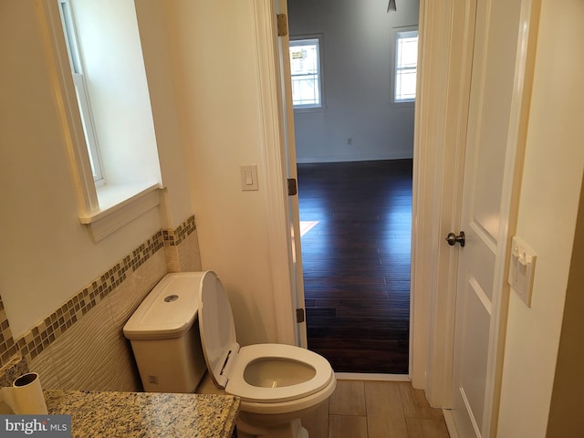 bathroom with hardwood / wood-style floors and toilet