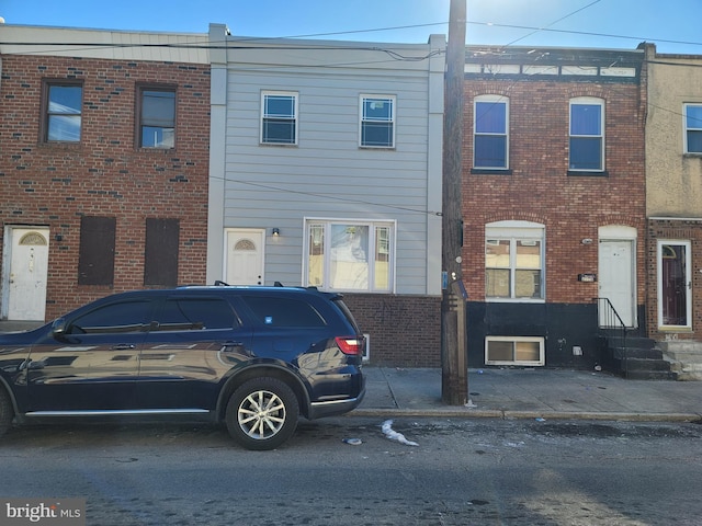 view of property featuring brick siding and entry steps
