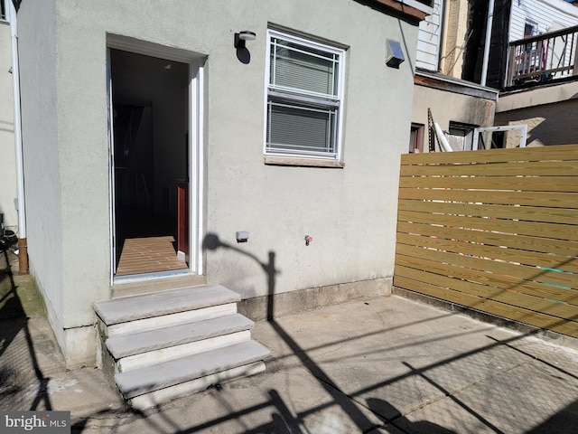 doorway to property with a patio area