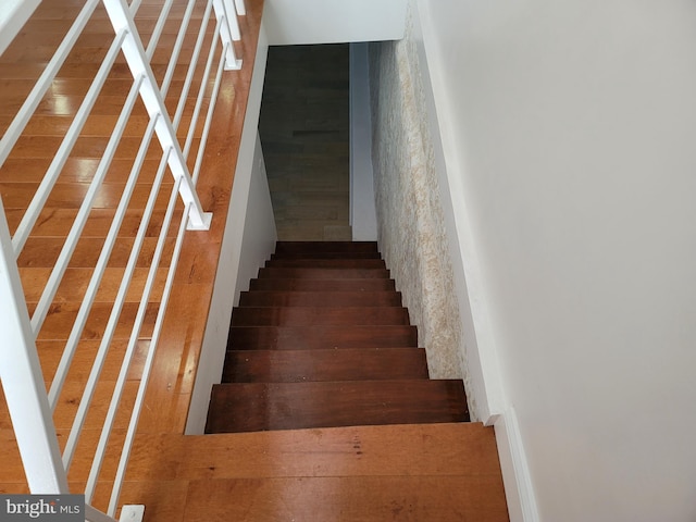 stairs with hardwood / wood-style floors