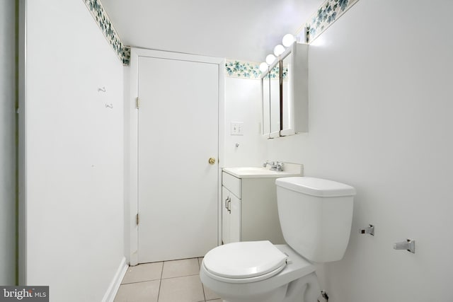 bathroom featuring tile patterned floors, vanity, and toilet