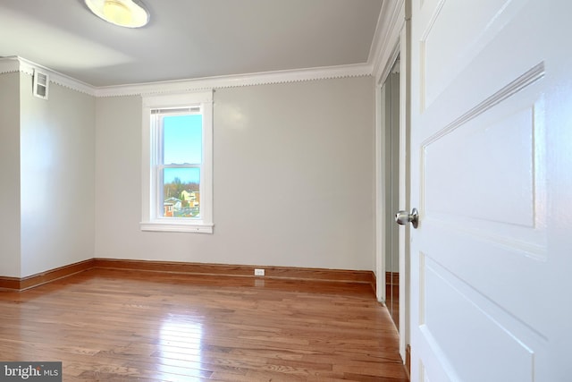 unfurnished bedroom with light hardwood / wood-style floors and crown molding