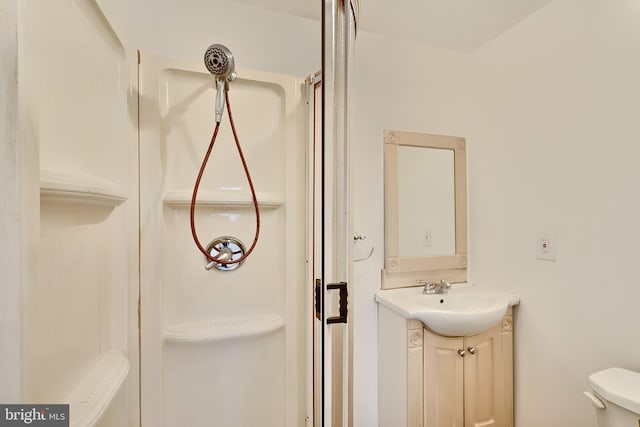 bathroom with vanity, toilet, and walk in shower