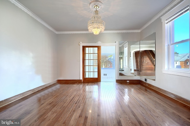 interior space with ornamental molding, a healthy amount of sunlight, and wood-type flooring