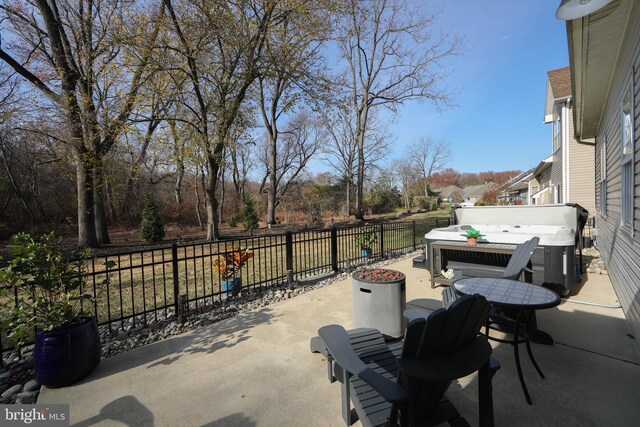 view of patio / terrace with a hot tub